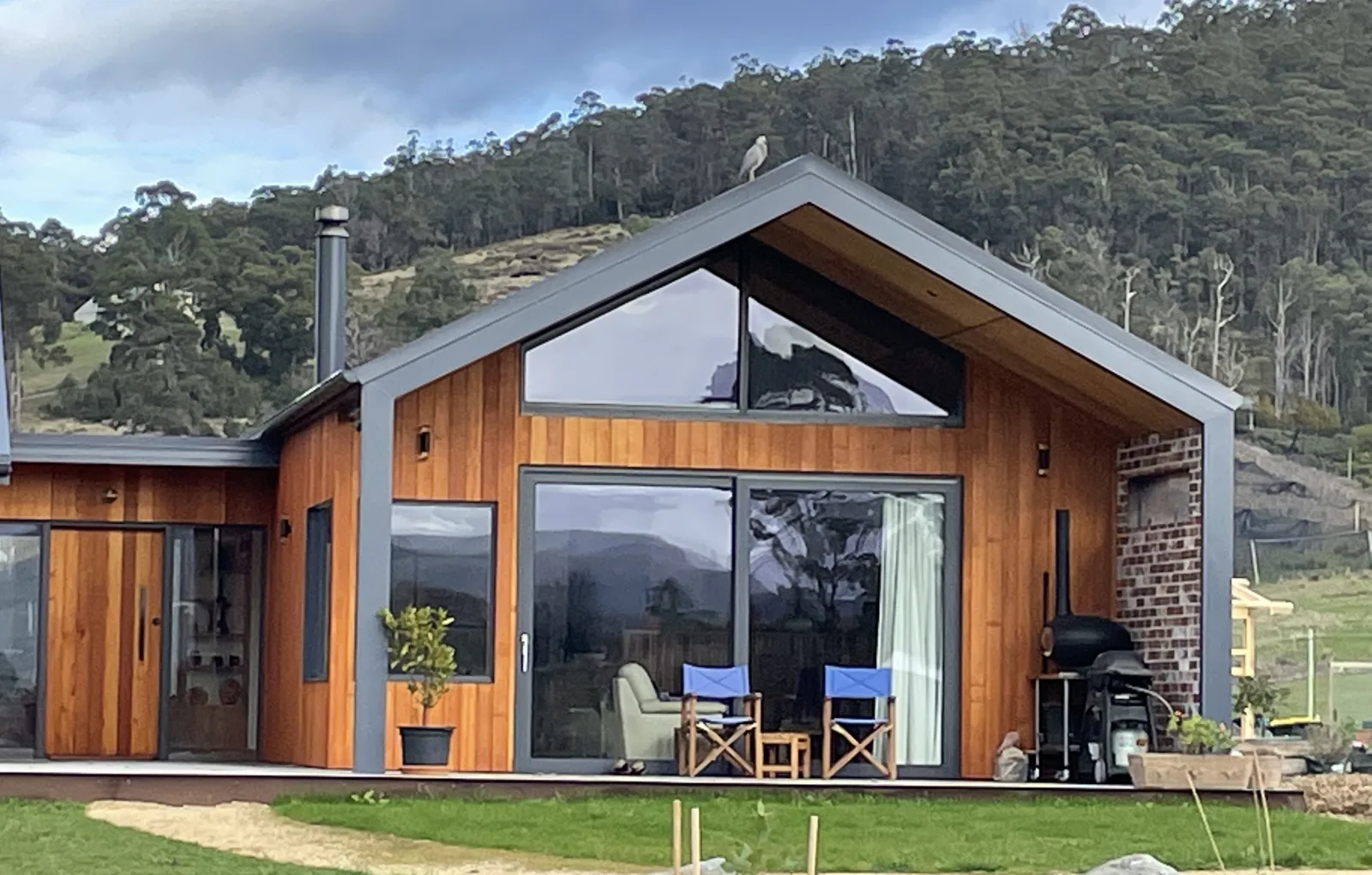A member home below a wooded hill